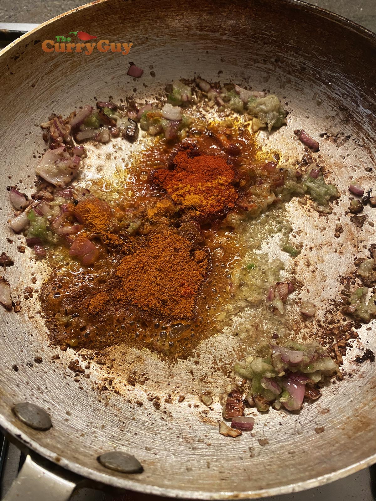 Adding ground spices to pan