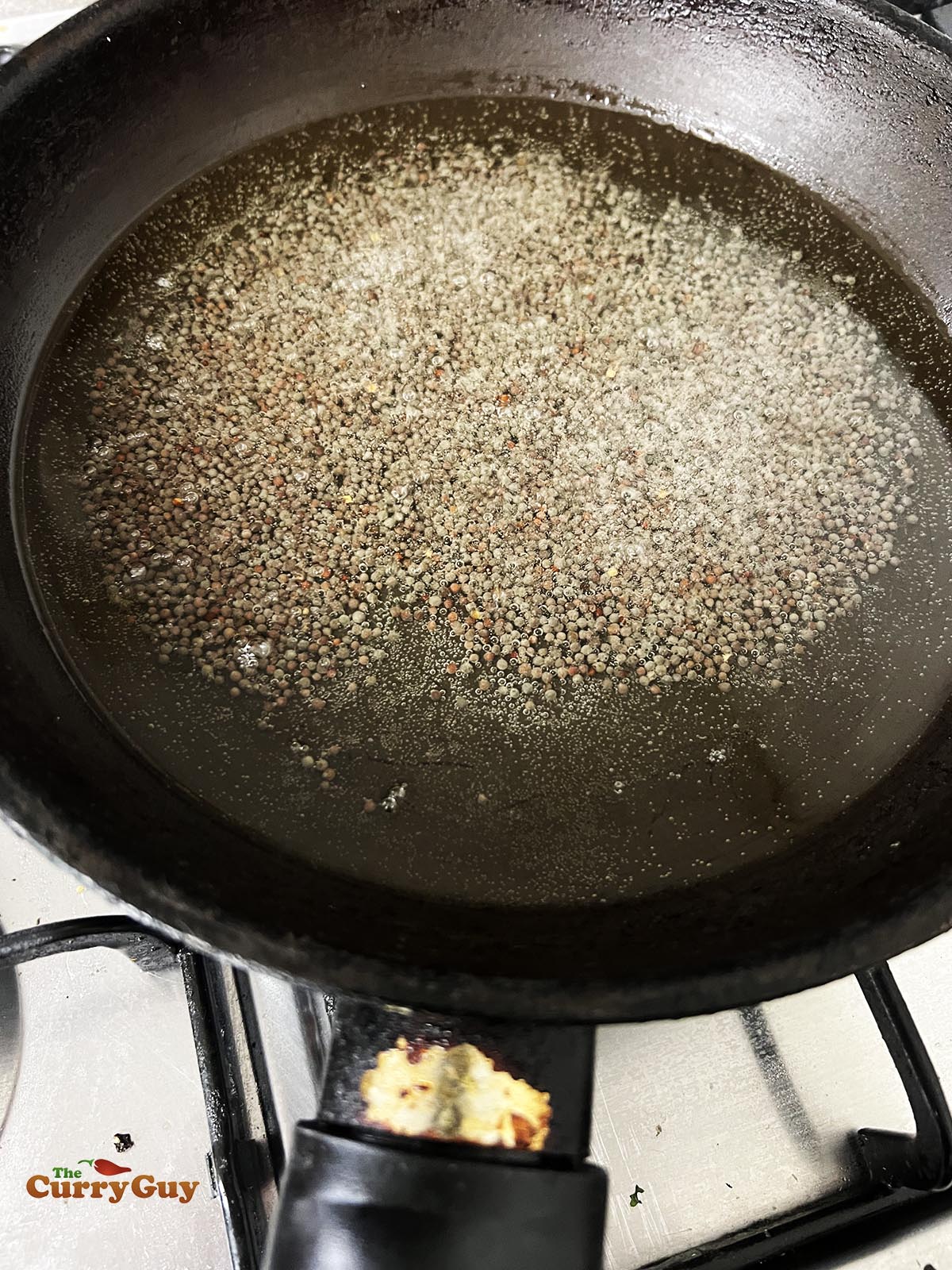 Frying mustard seeds.