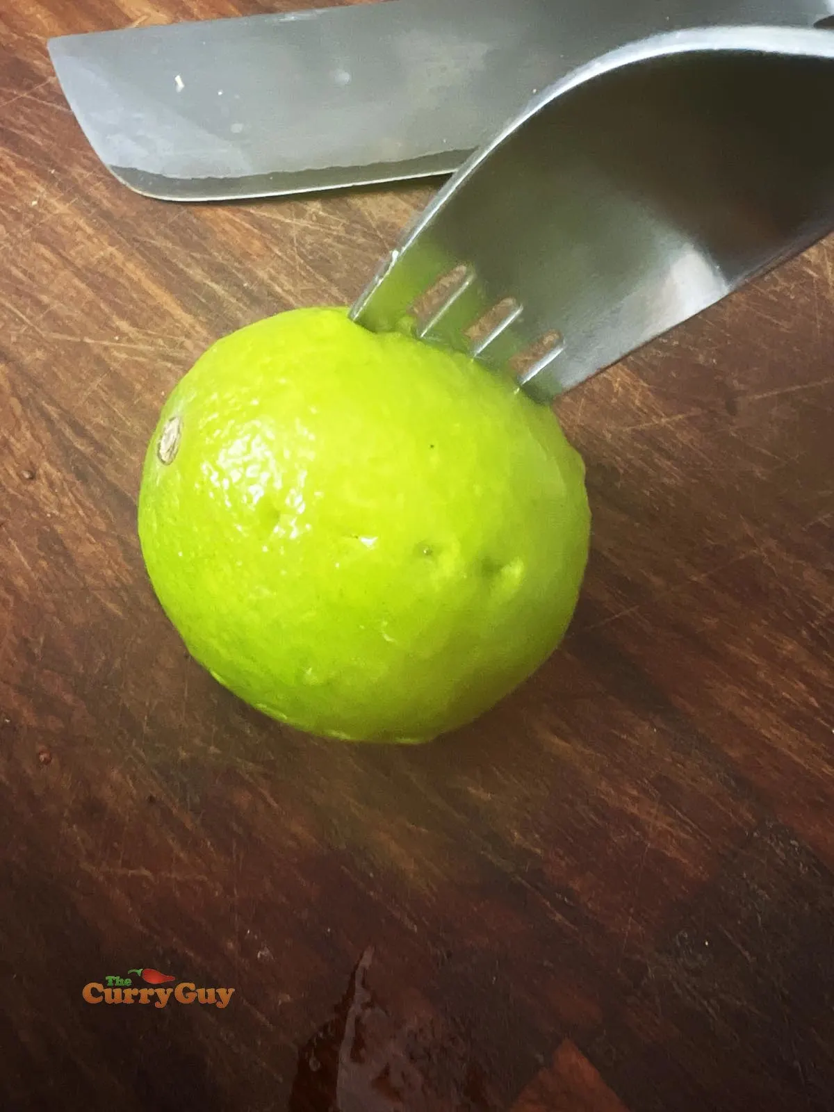 Stabbing limes with a fork in preparation for the pickle