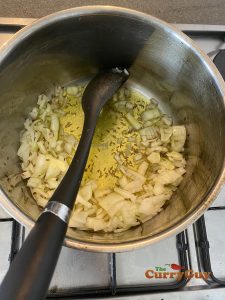 Adding chopped onions to the ghee