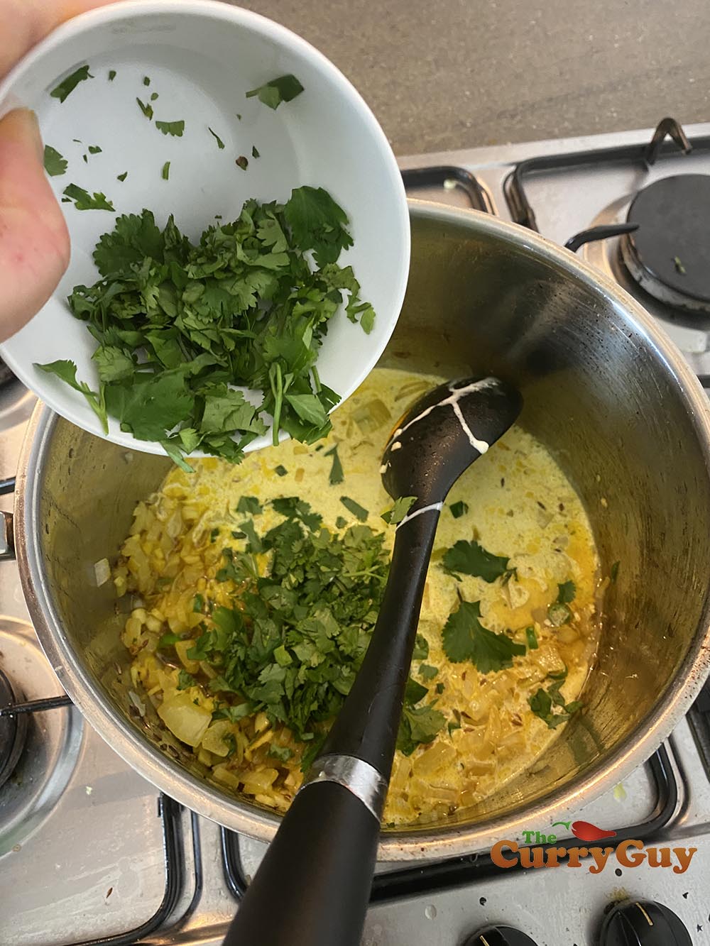 adding coriander (cilantro) to pan