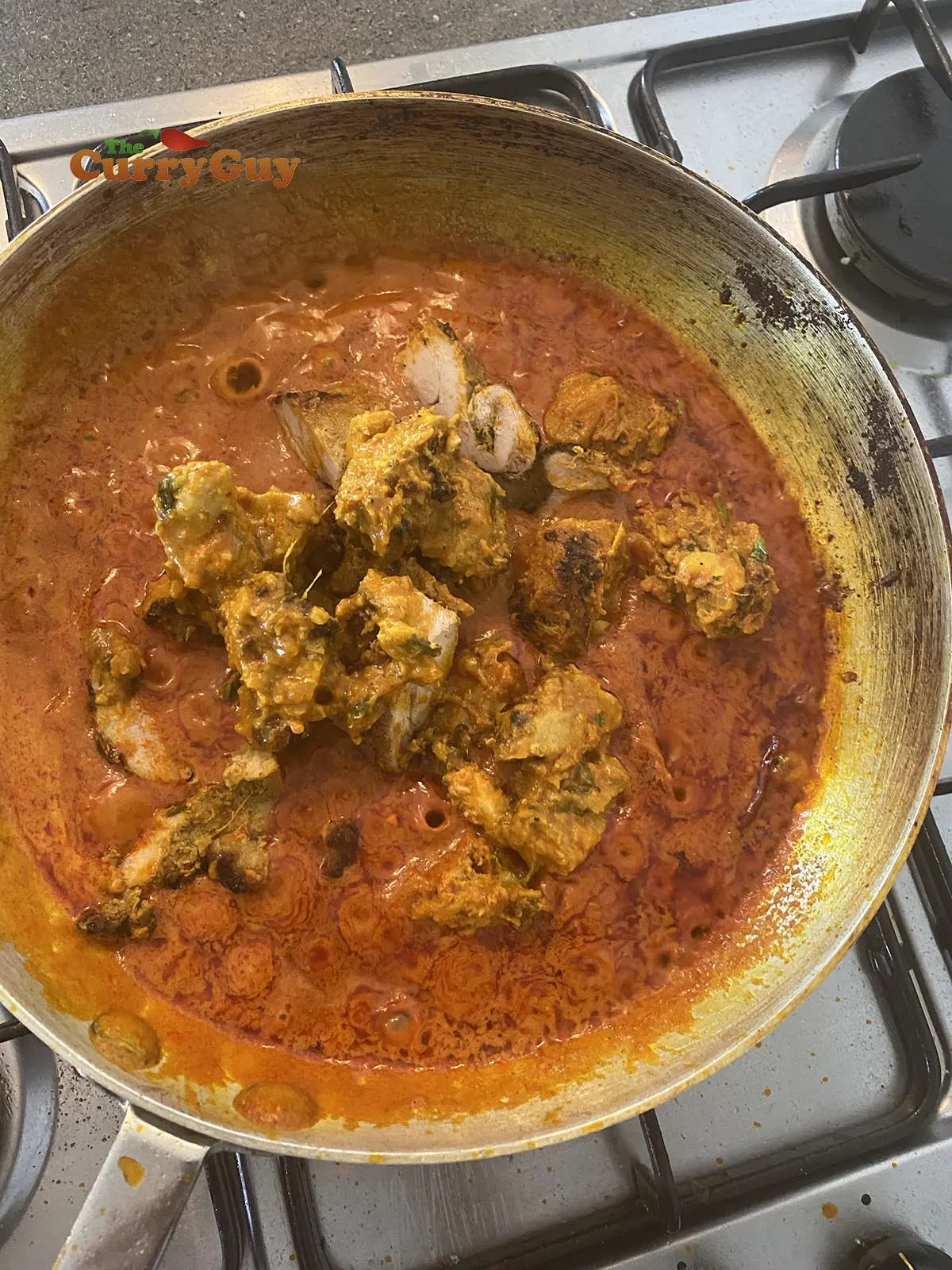 Adding chicken to the chicken madras curry