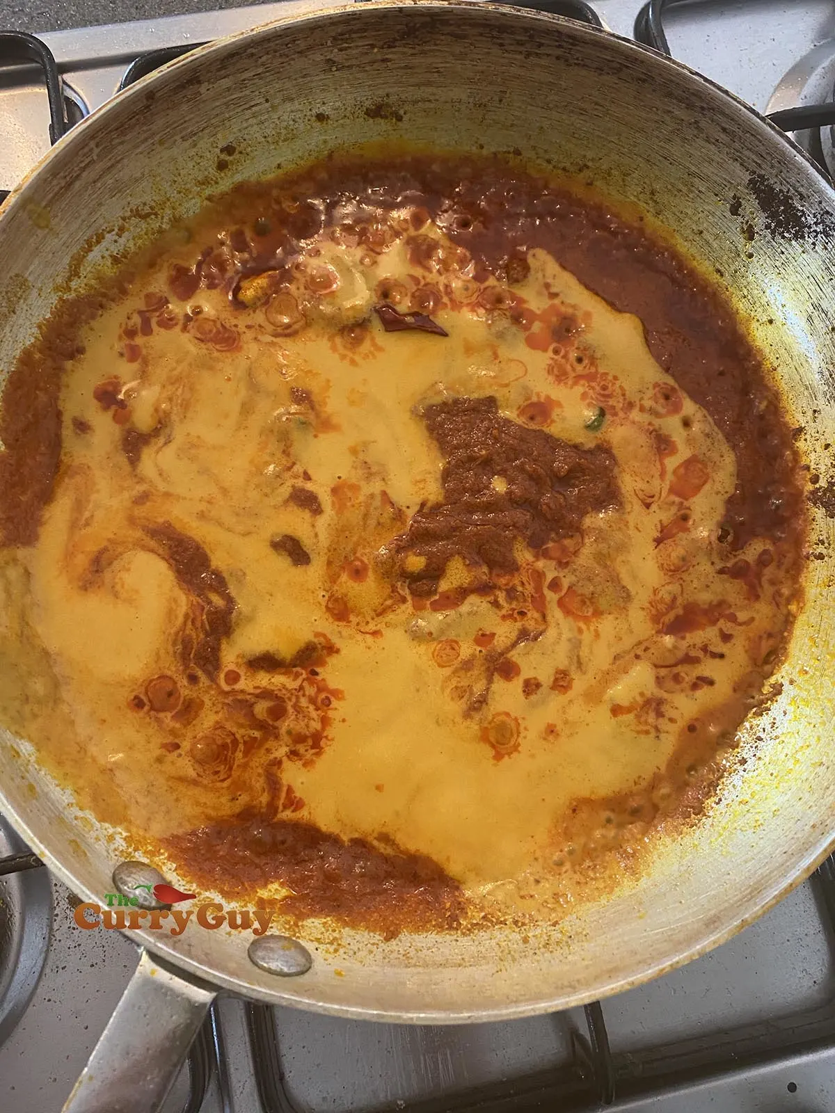 Adding base curry sauce to pan
