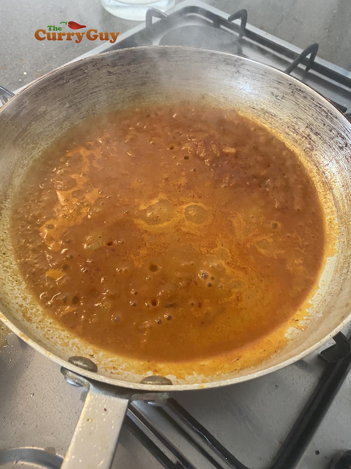 Adding base sauce to the pan