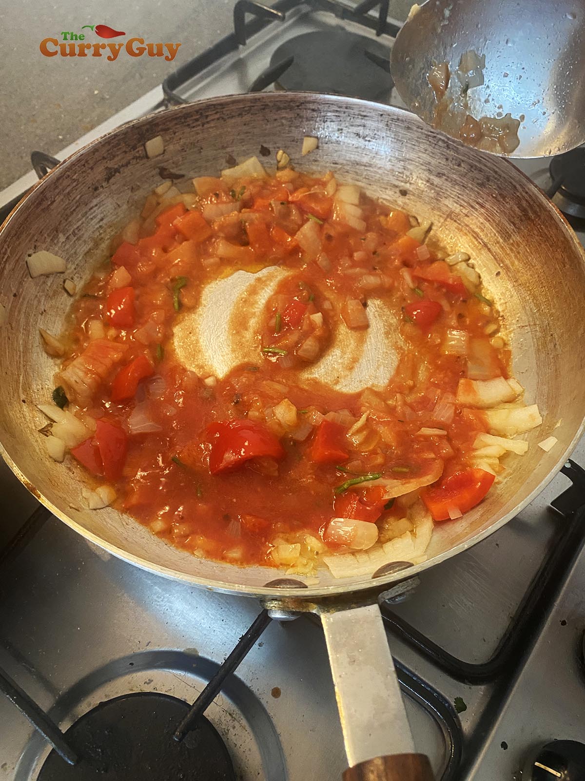 stirring in the tomato puree