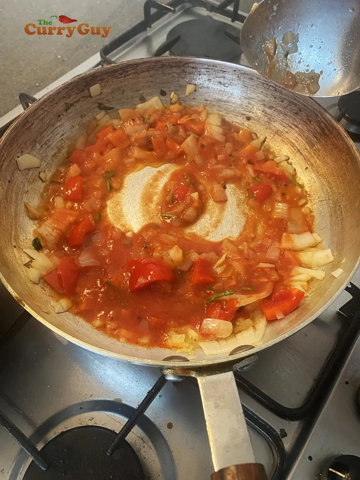 stirring in the tomato puree