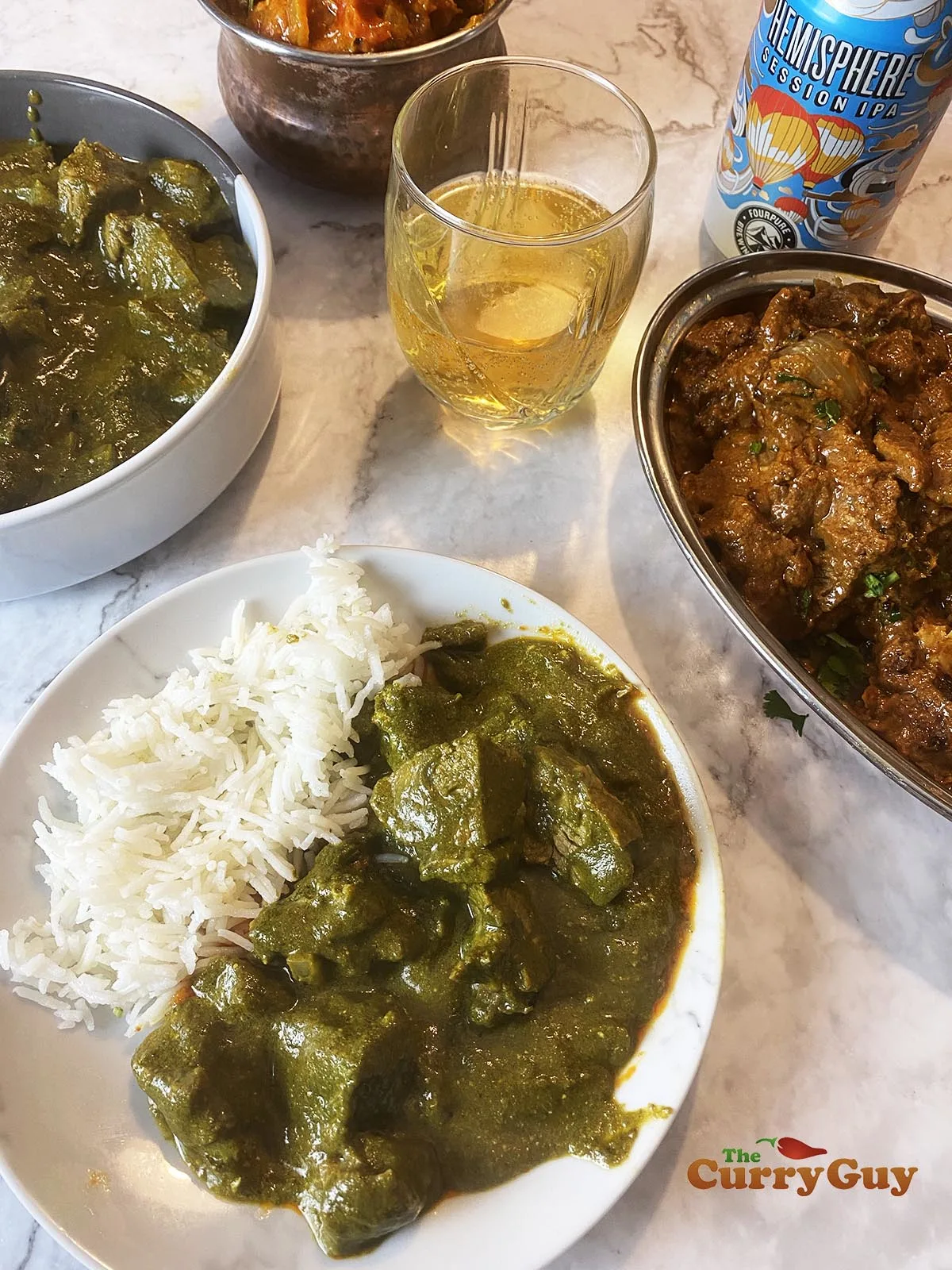 Finished lamb saag curry with other curries.