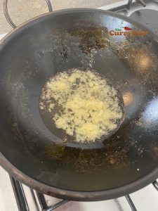 Adding garlic and ginger paste to the pan