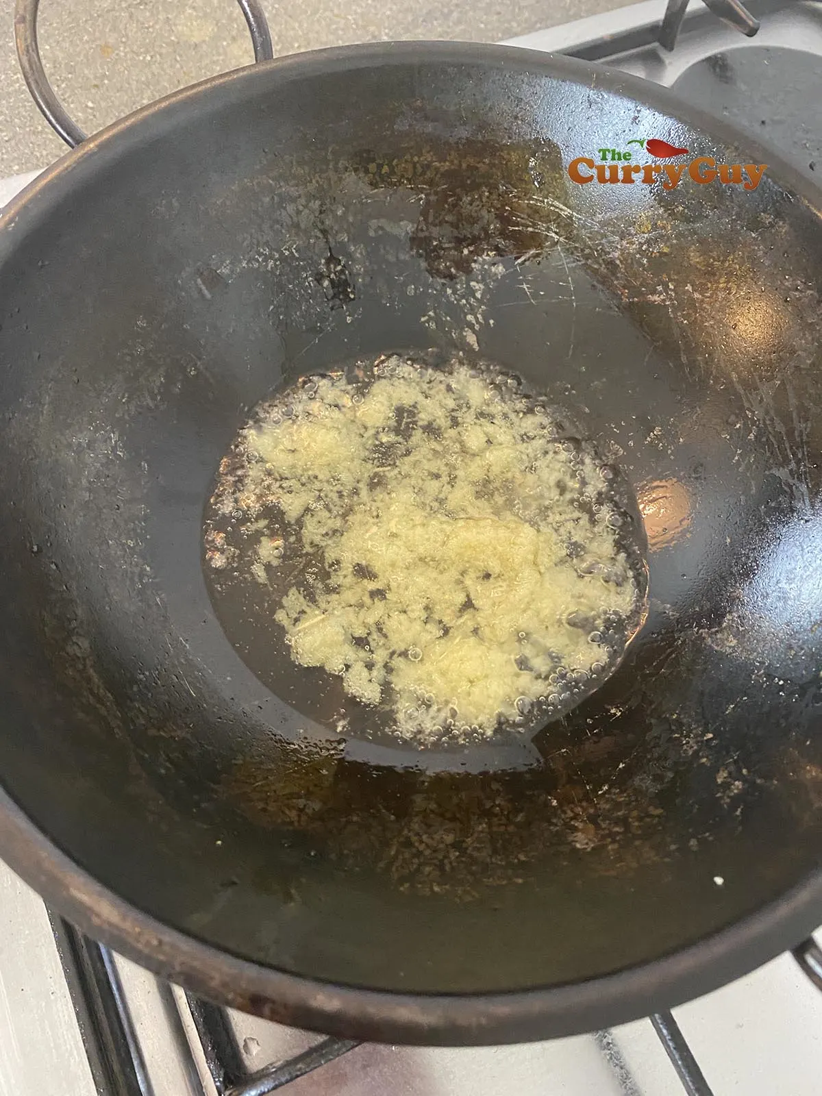 Adding garlic and ginger paste to the pan