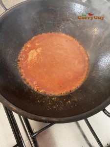 Stirring in the tomato puree