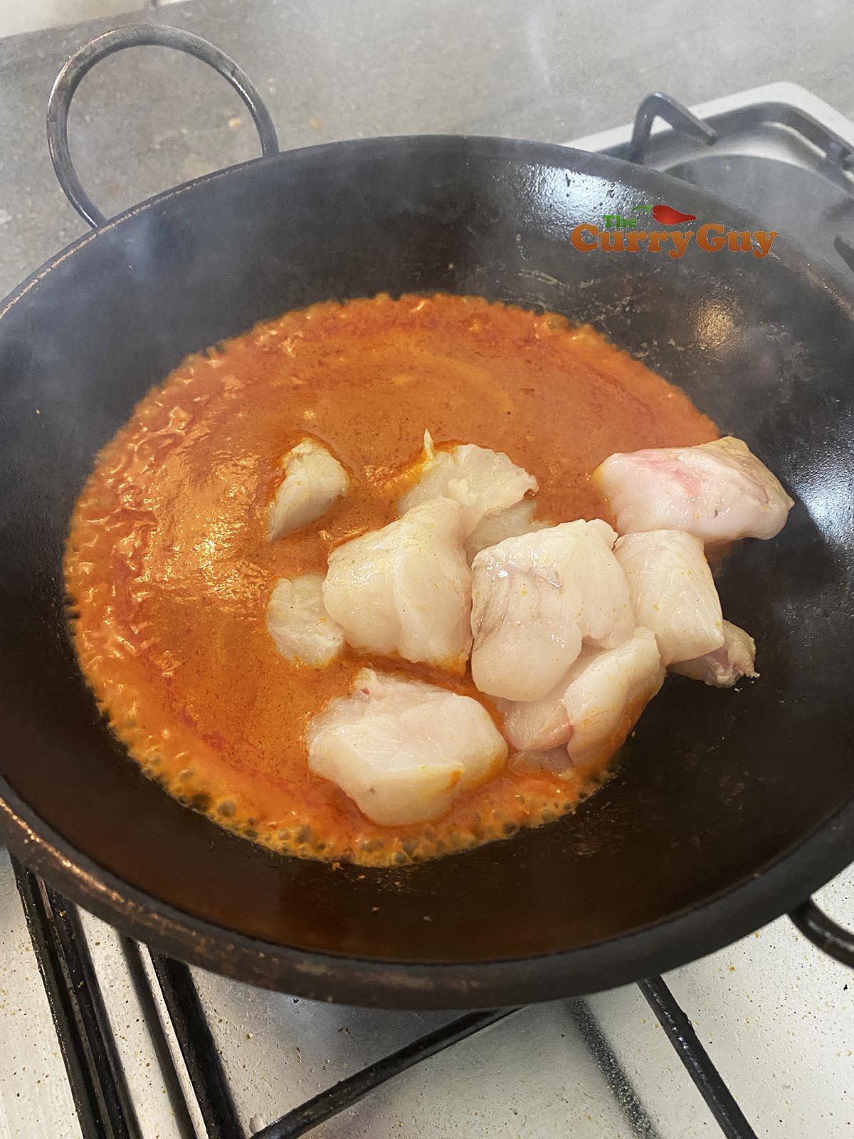 Adding monkfish to the pan