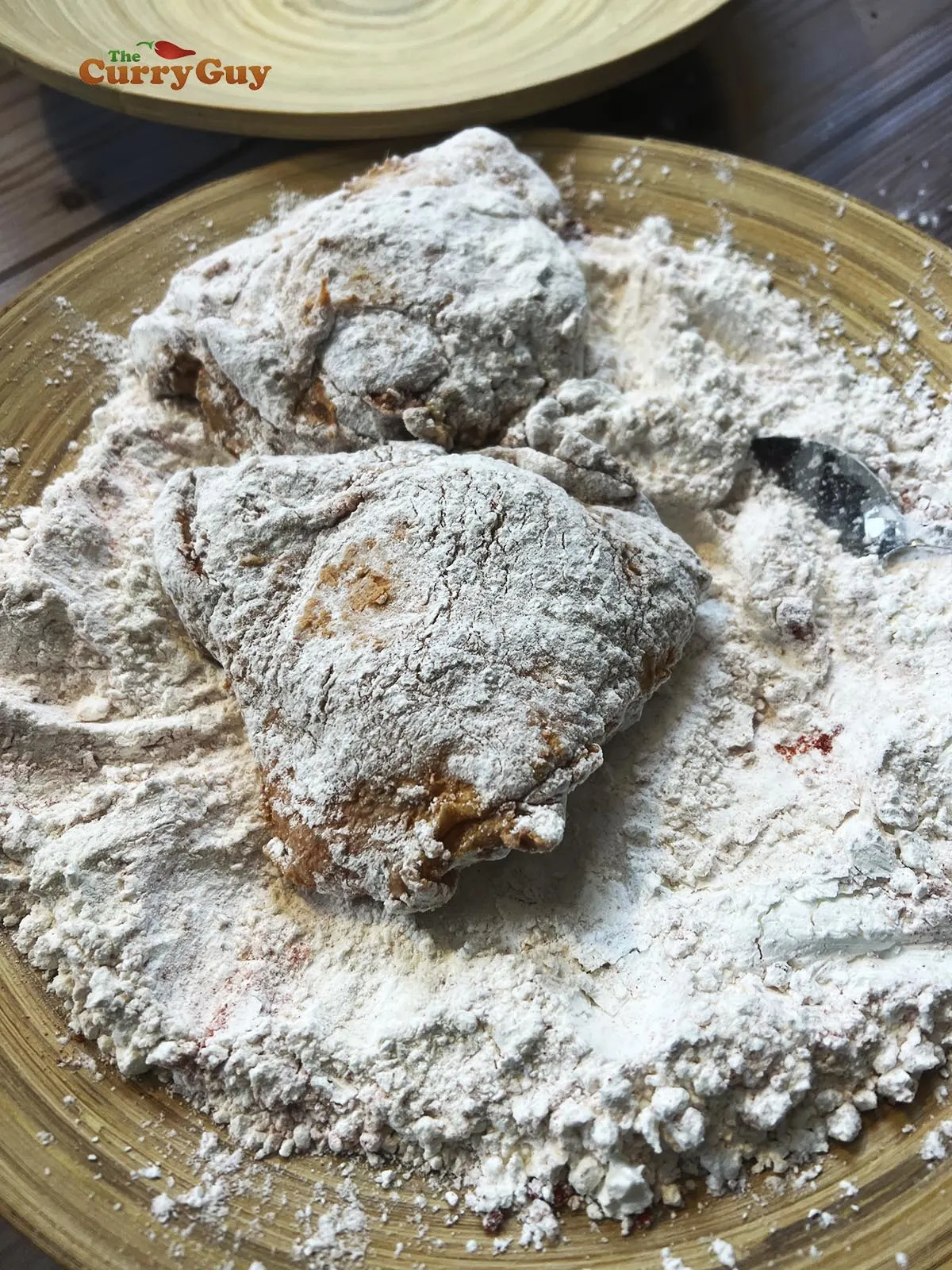 Chicken coated in flour, ready for frying.