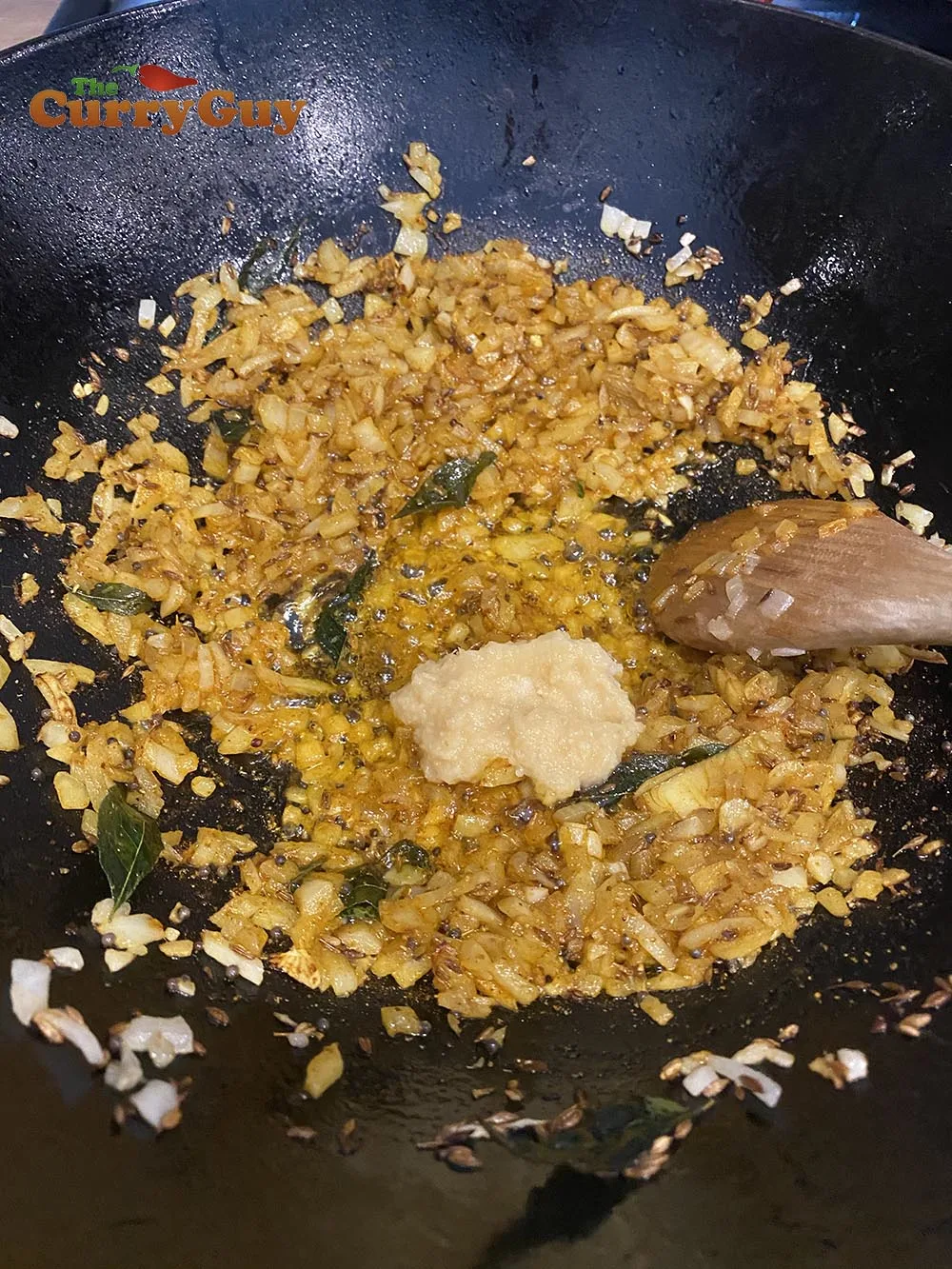 Adding garlic and ginger paste to the base masala