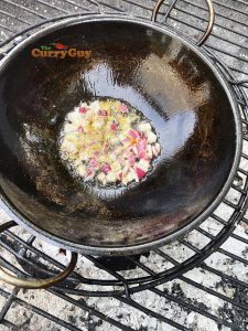 Frying onions in balti bowl