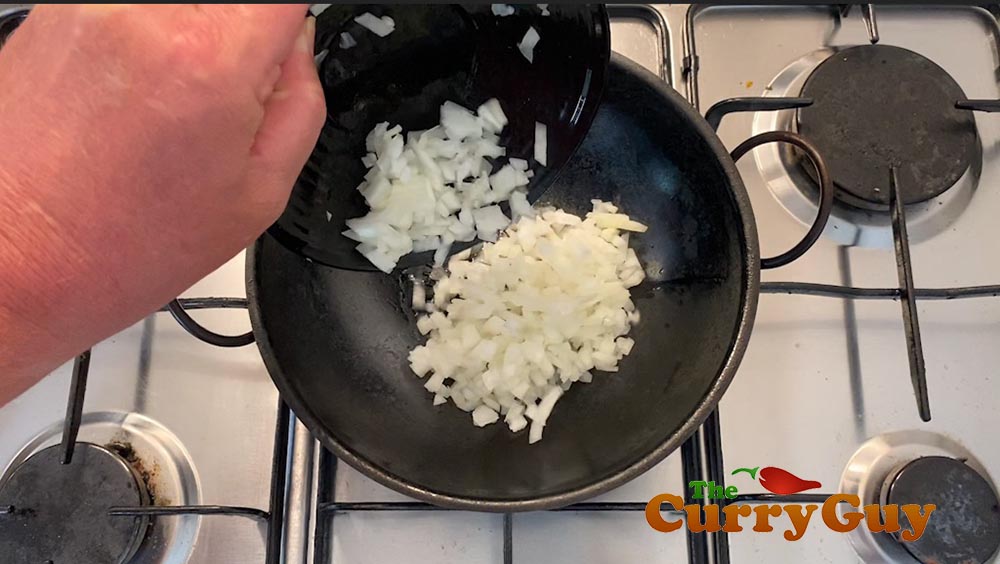 Adding onions to the Balti bowl