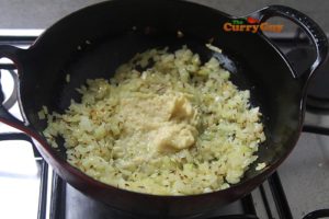 Adding garlic and ginger paste to sauce.