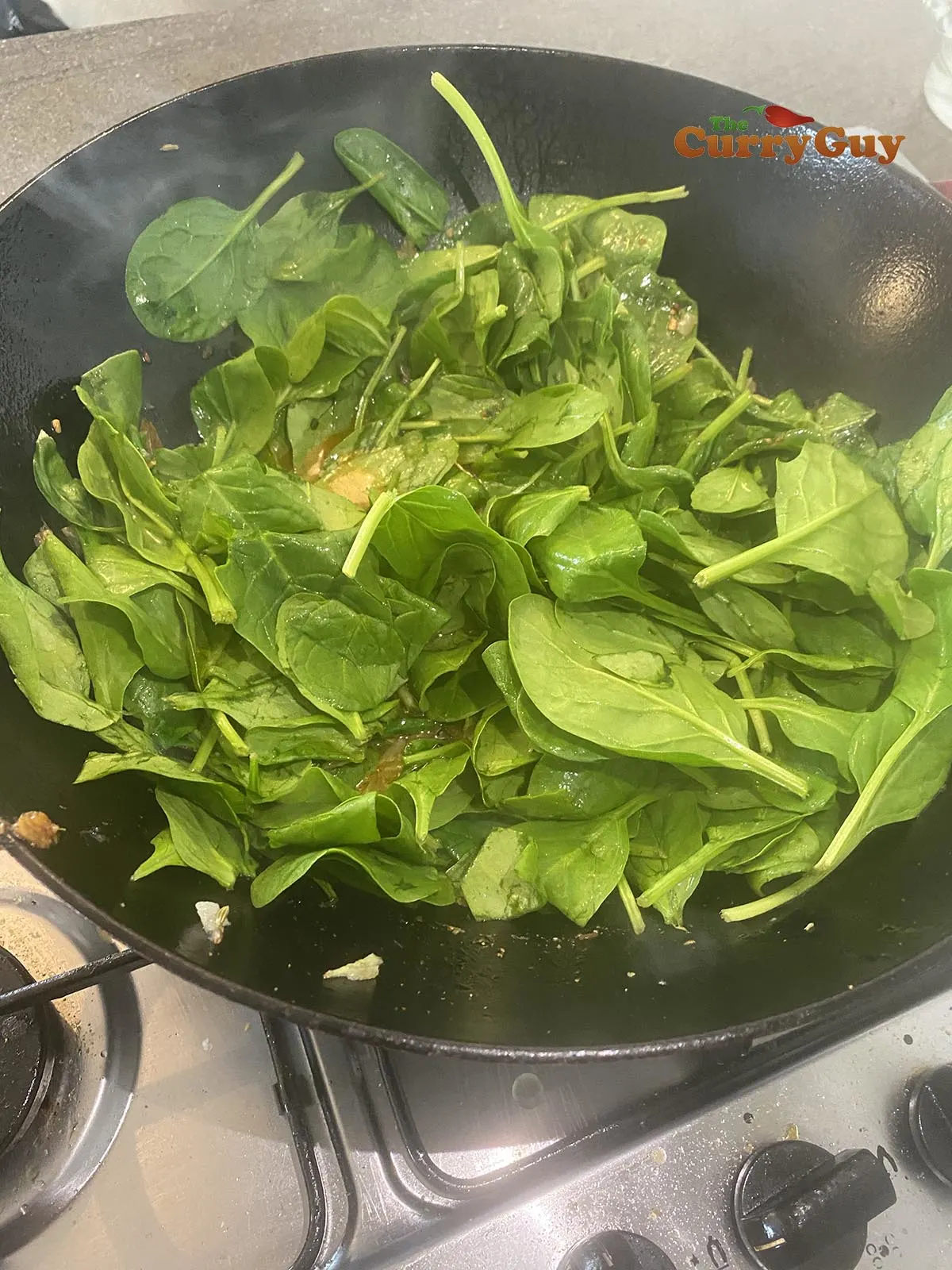 Adding spinach to the pan