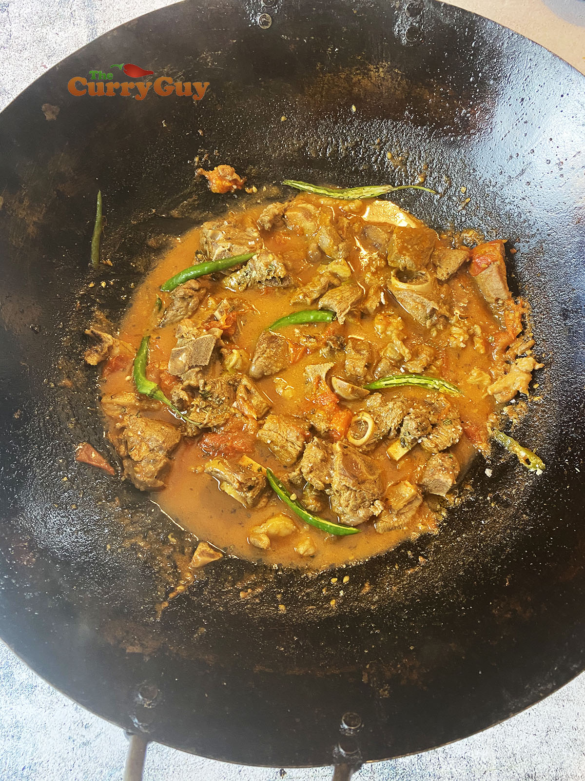 Adding chillies to karahi