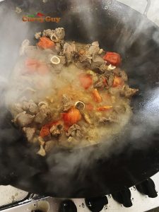 adding tomatoes to pan