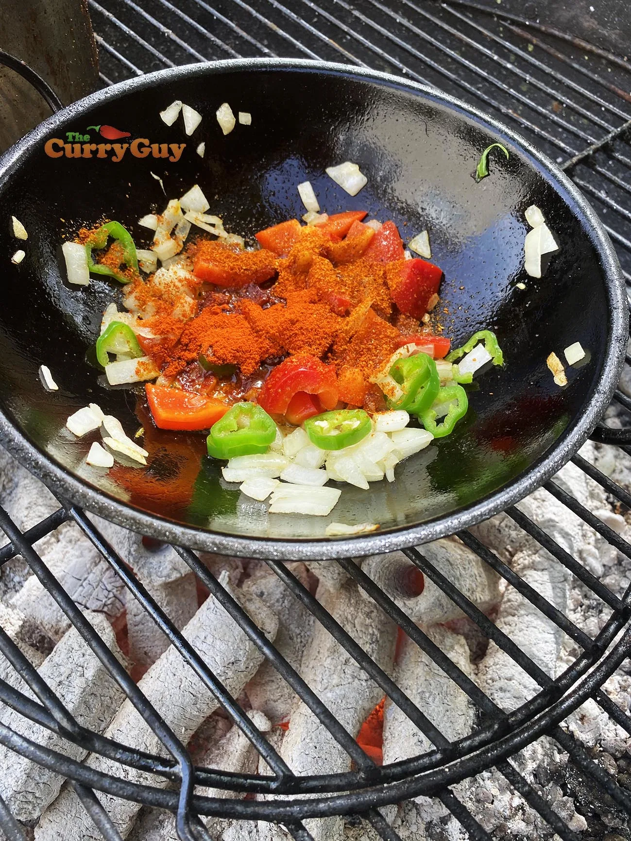 Adding spices and bell pepper to pan
