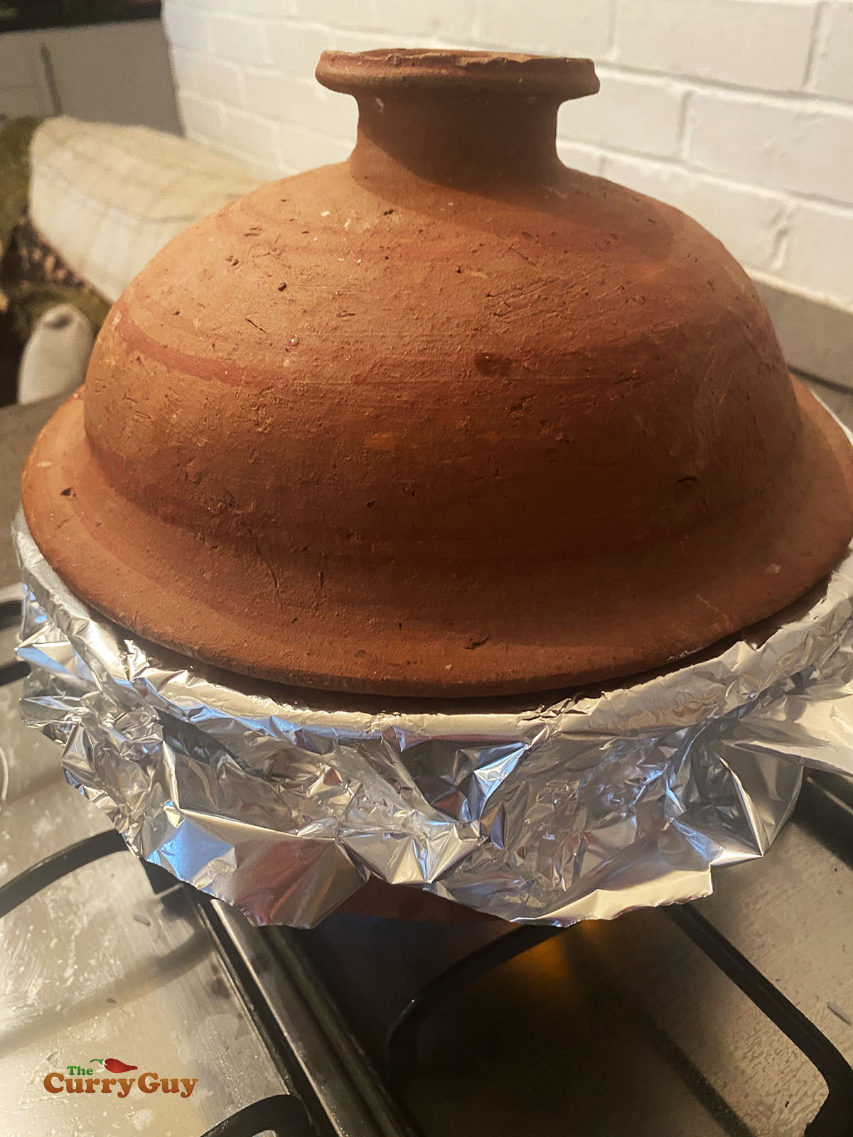 Cooking the biryani in a sealed pot.