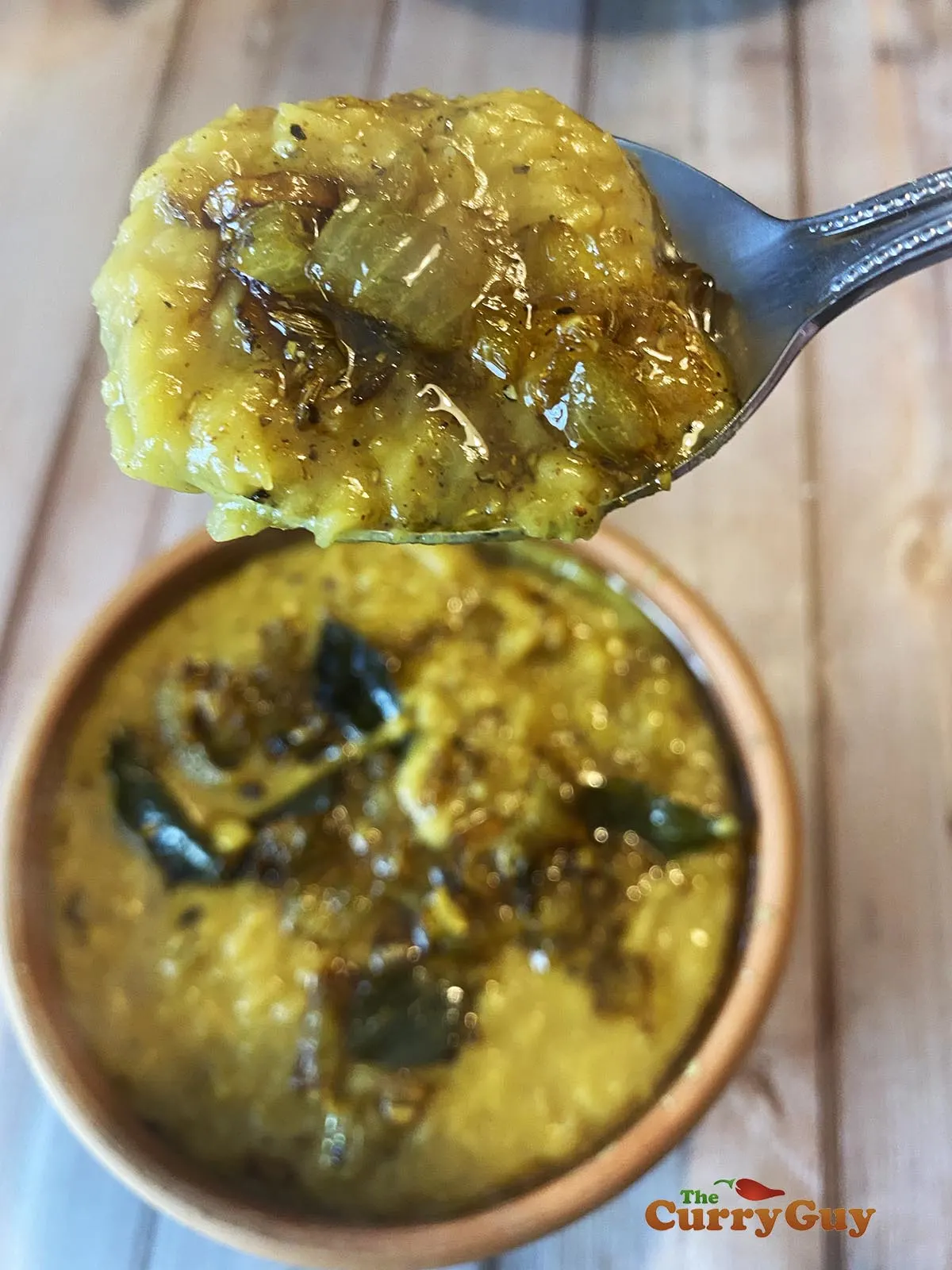 Spoon with dhal on it.
