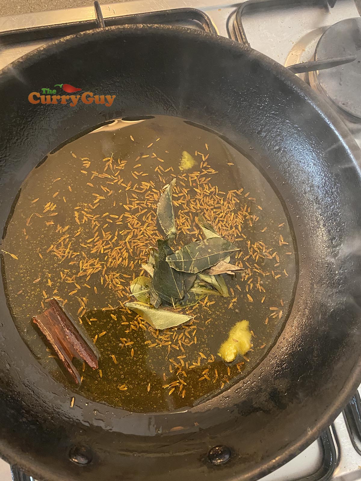 Adding whole spices to the pan