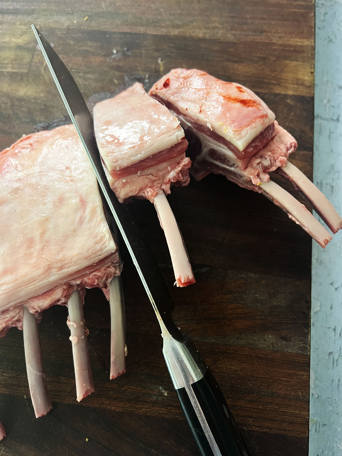 Slicing a rack of lamb into chops.