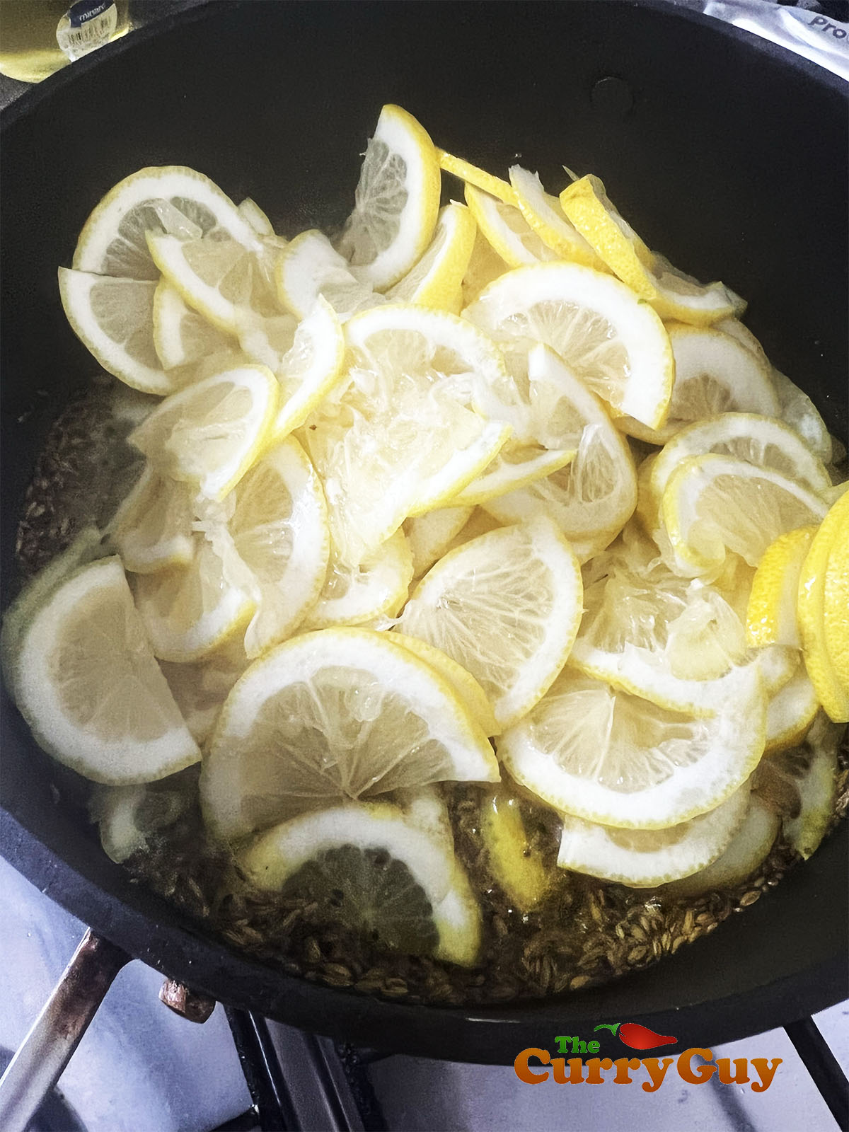 Adding the lemons to the pan.