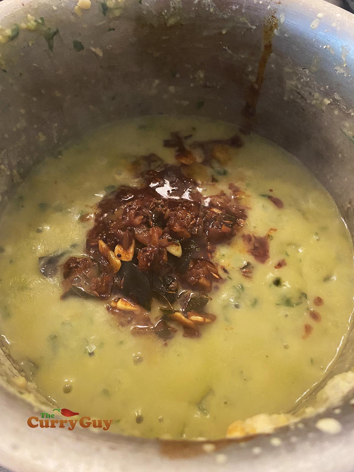 Finishing spinach dhal