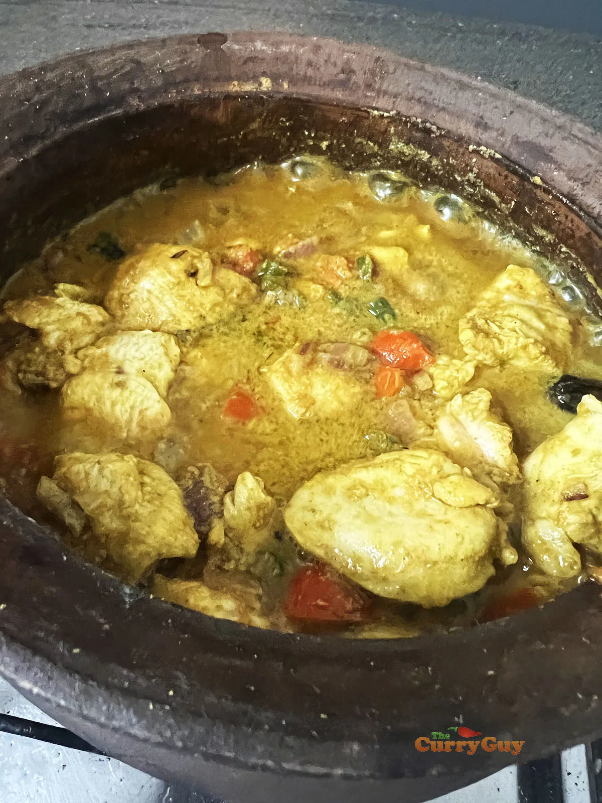Simmering chicken in the spices and stock