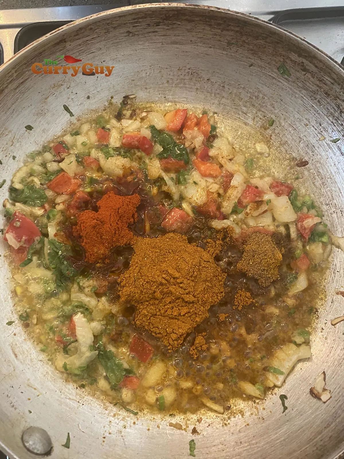 Adding ground spices to the pan