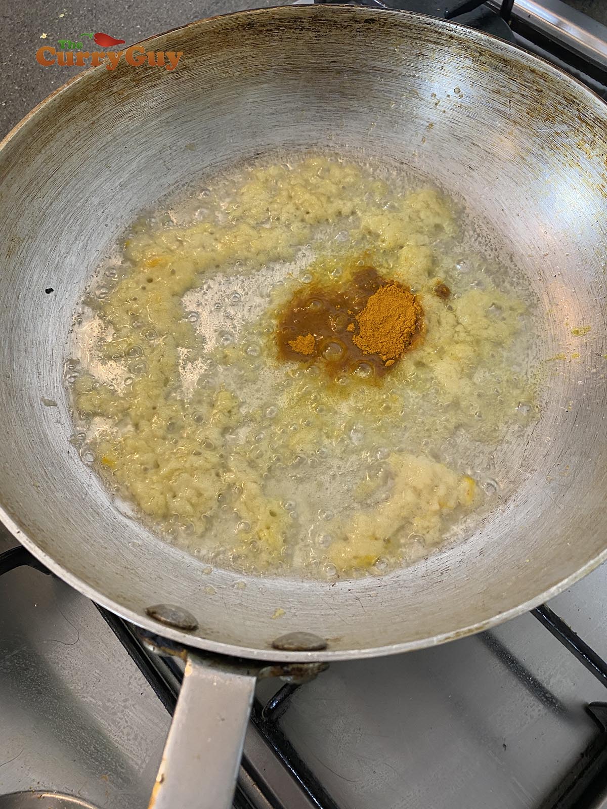 Adding turmeric to the pan