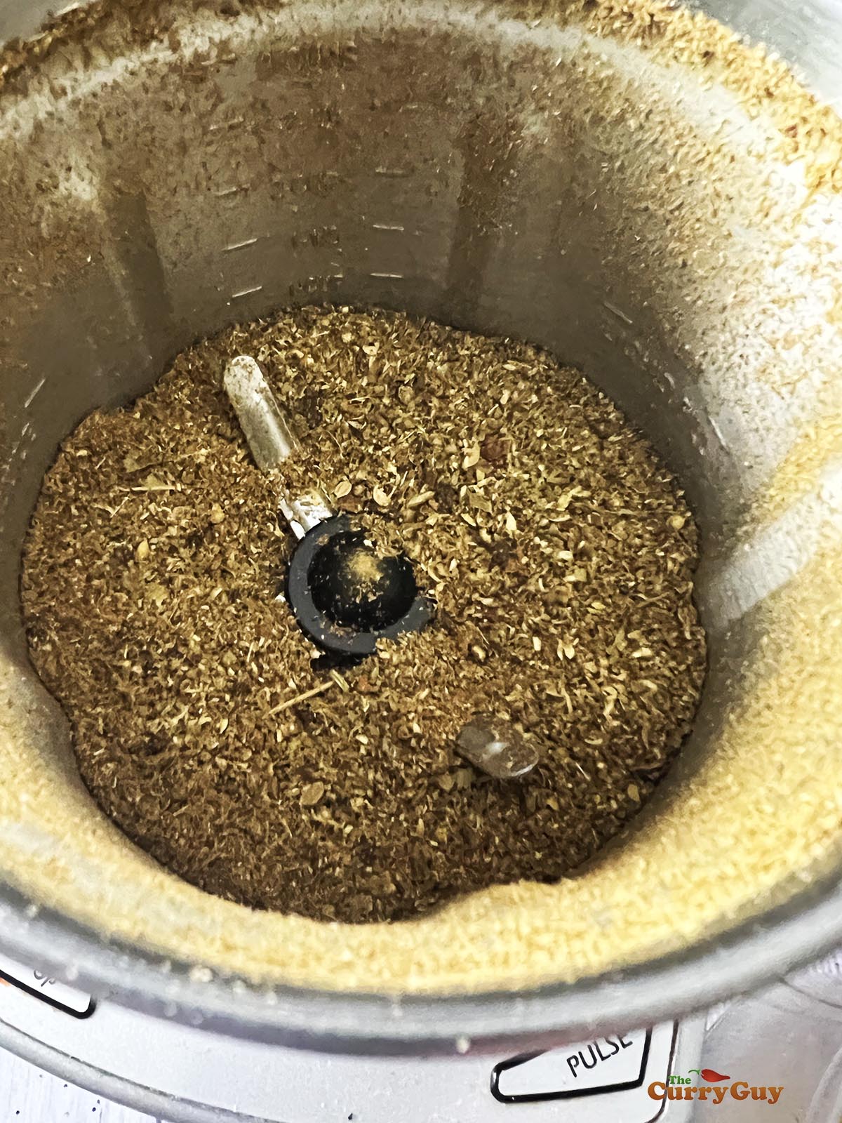 Grinding the spices in a spice grinder.