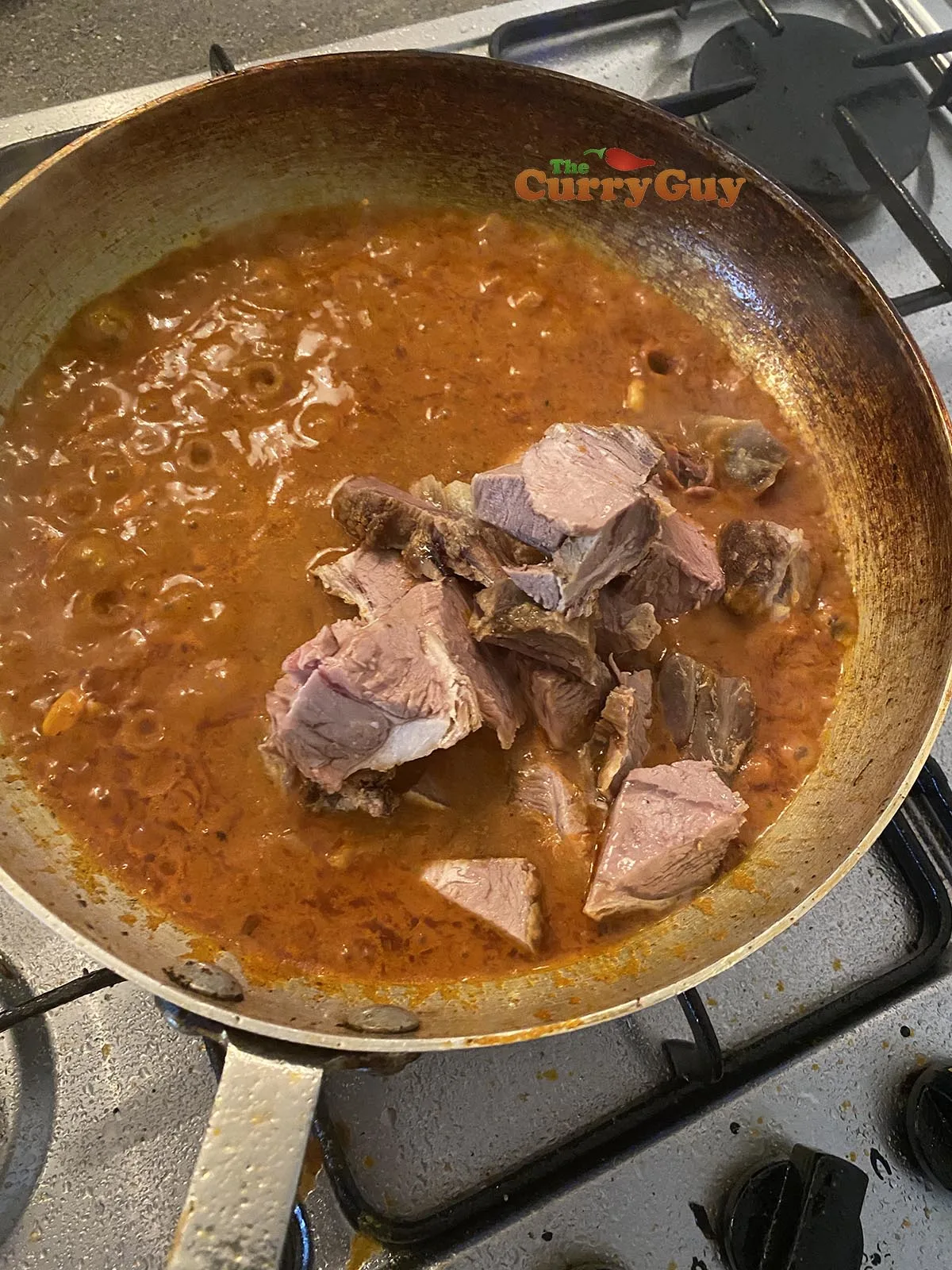 adding base sauce and meat to the pan