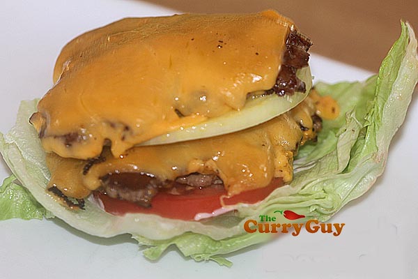 Stacking a lettuce wrap with cheese burgers