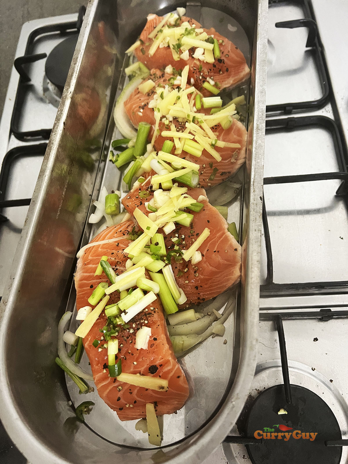 Salmon topped with ginger garlic and chillies in a steamer