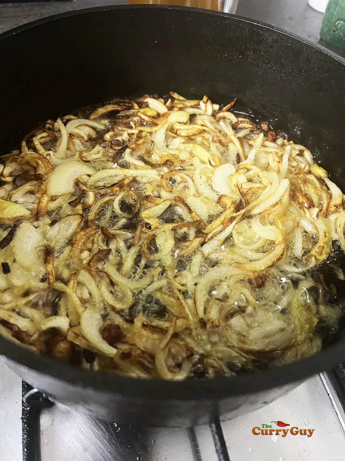 Frying onions for the marinade.