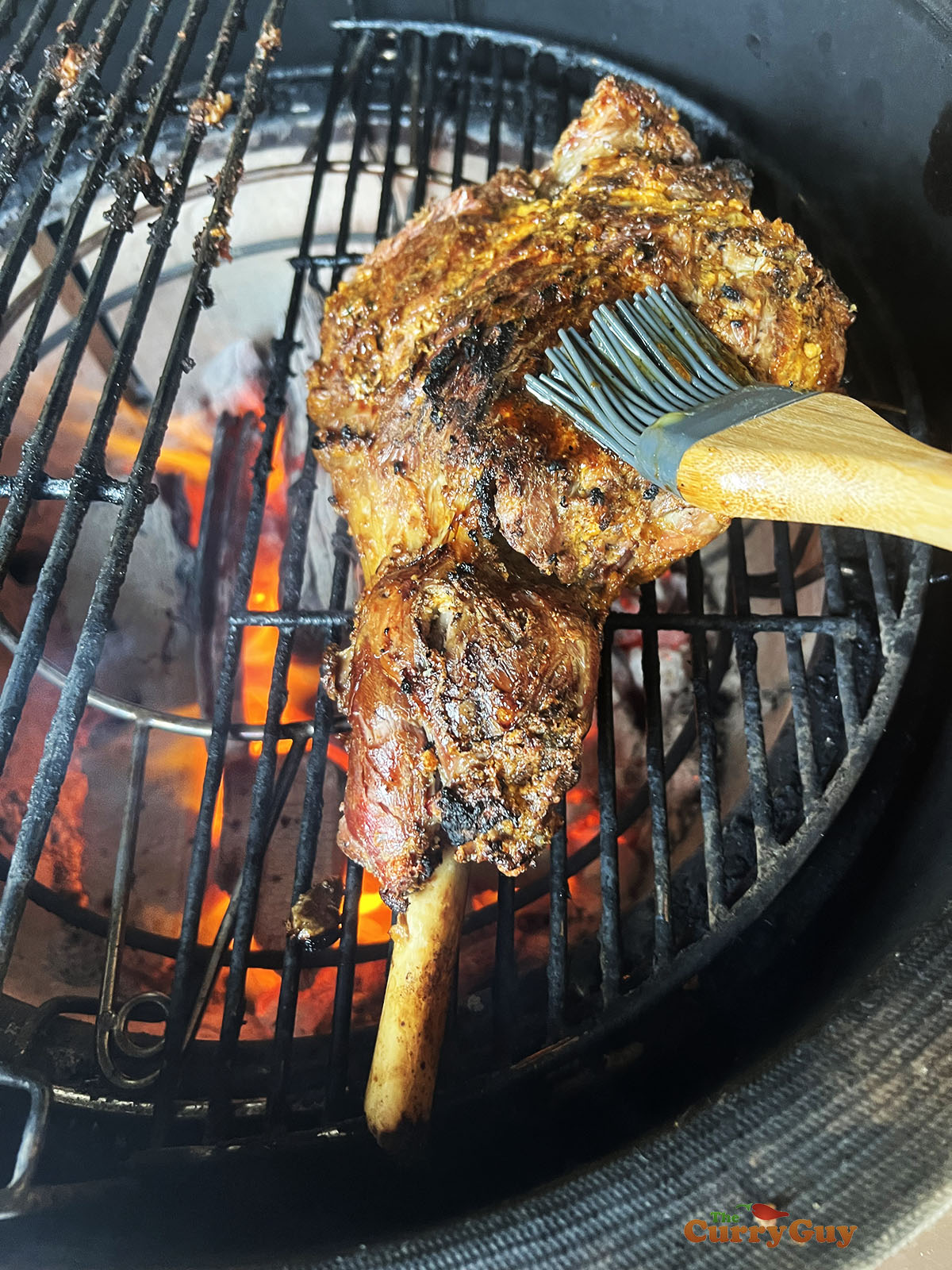 The lamb raan on a hot barbecue grill. 