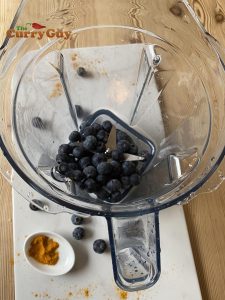 Adding the blueberries to the blender