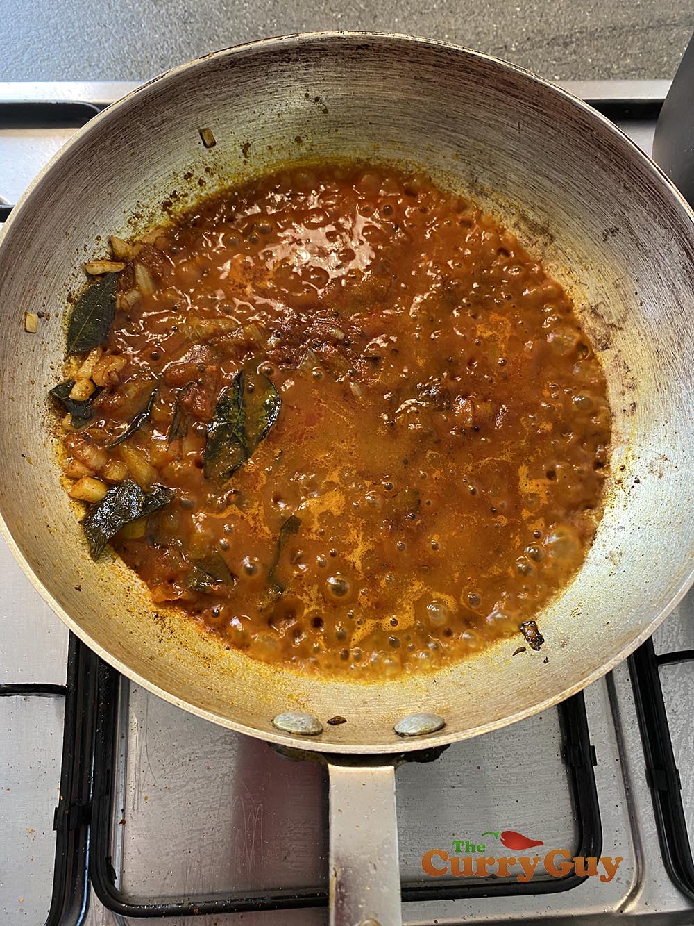 Adding base sauce to the curry