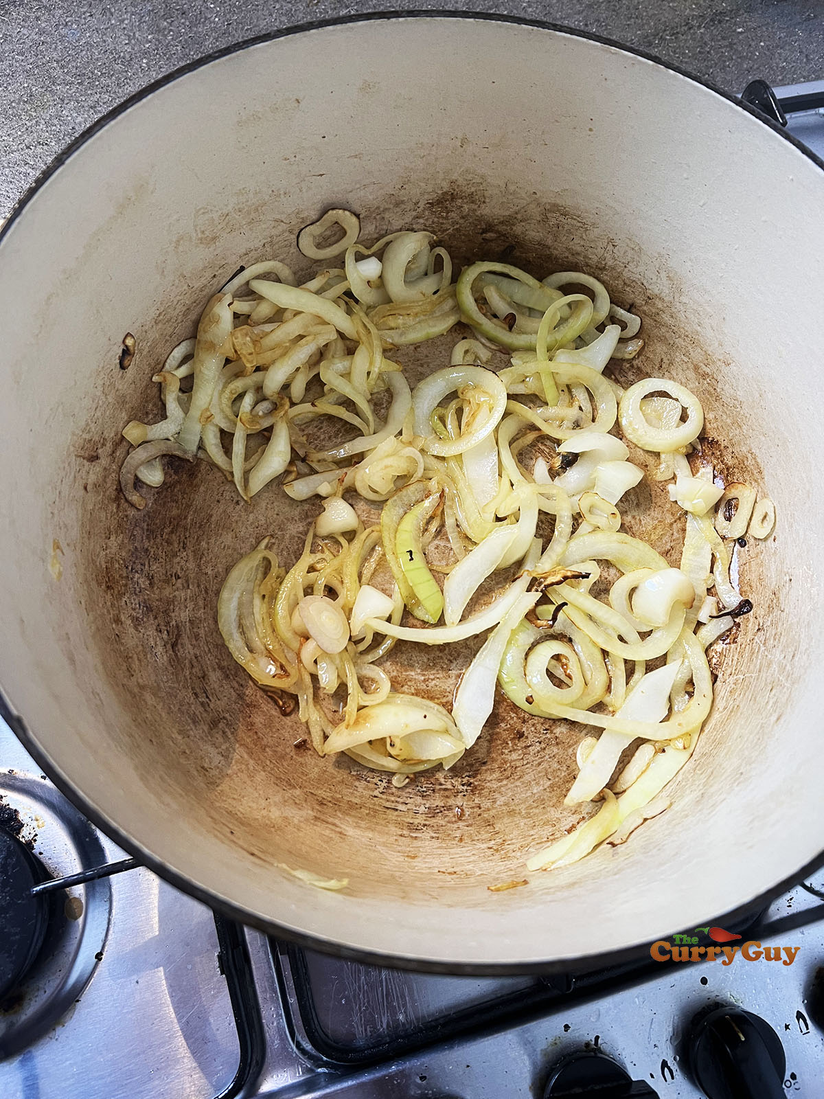 Frying onions in a pot.