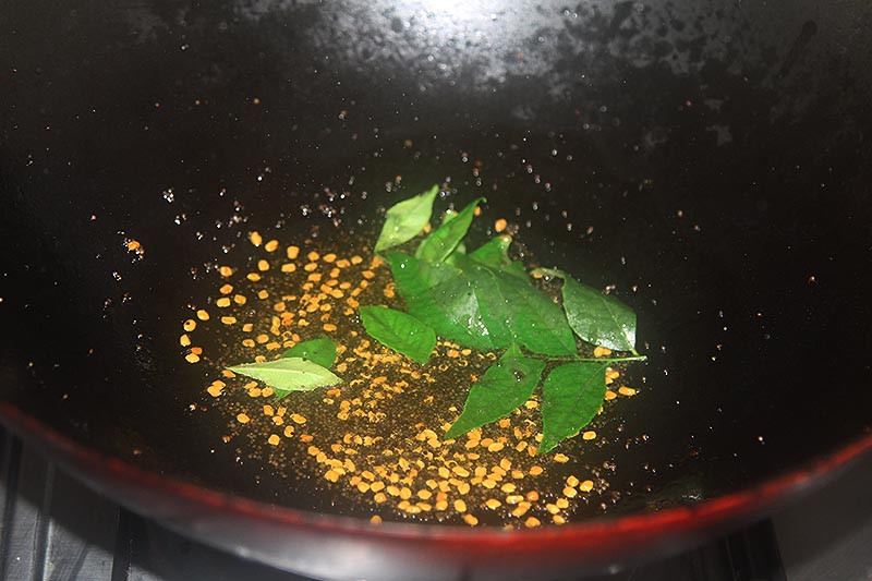 tempering mustard seeds, curry leaves and fenugreek seeds in the oil