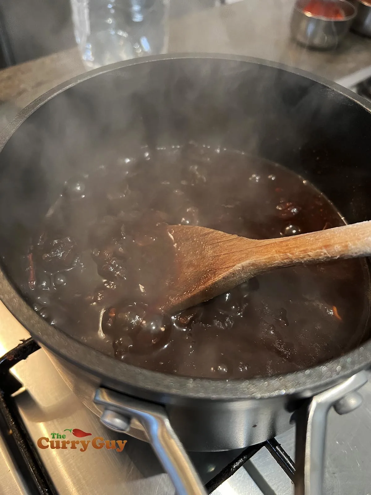 Breaking the tamarind down in the pan
