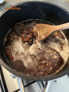 Adding tamarind to pan with water