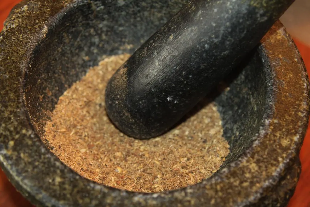 Grinding the toasted spices.
