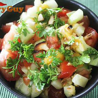 A Mango Salad With Tomato, Cucumber, Lime And Chillies