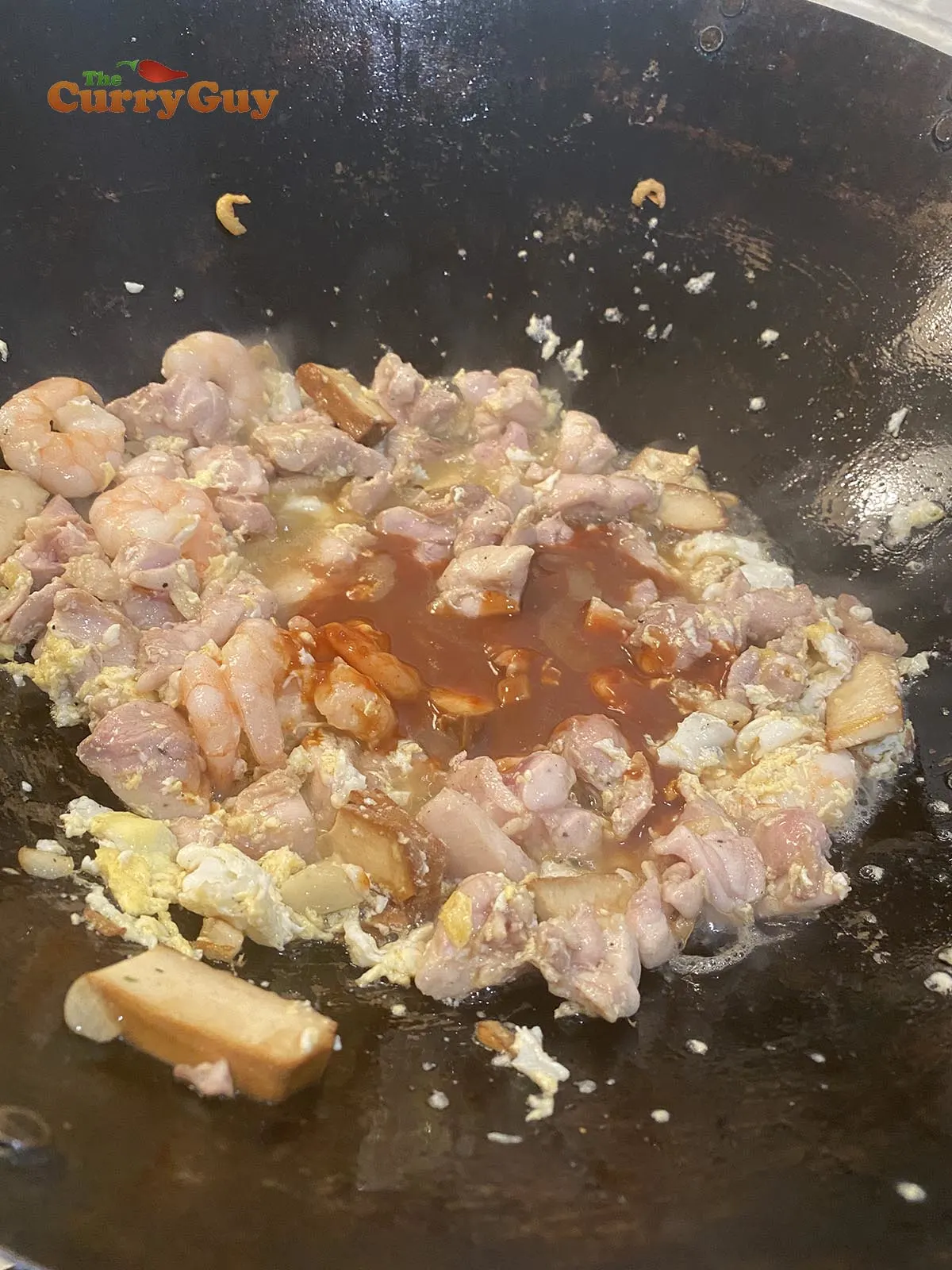 Adding sauce to wok