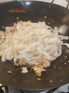 Adding noodles to pan