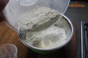 Adding flour to indian flat bread.